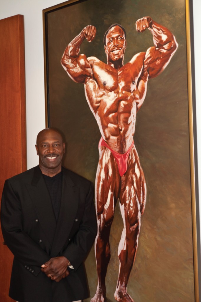 Former Mr. Olympia Lee Haney poses with the oil painting of his likeness.