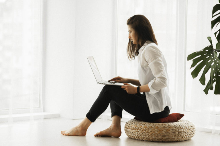 A woman on her computer at home.