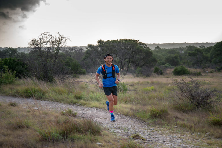 A man running on Slaughter Creek Trail.