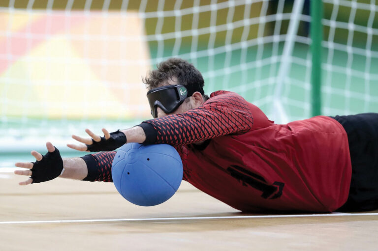 Someone diving for the ball in goalball.