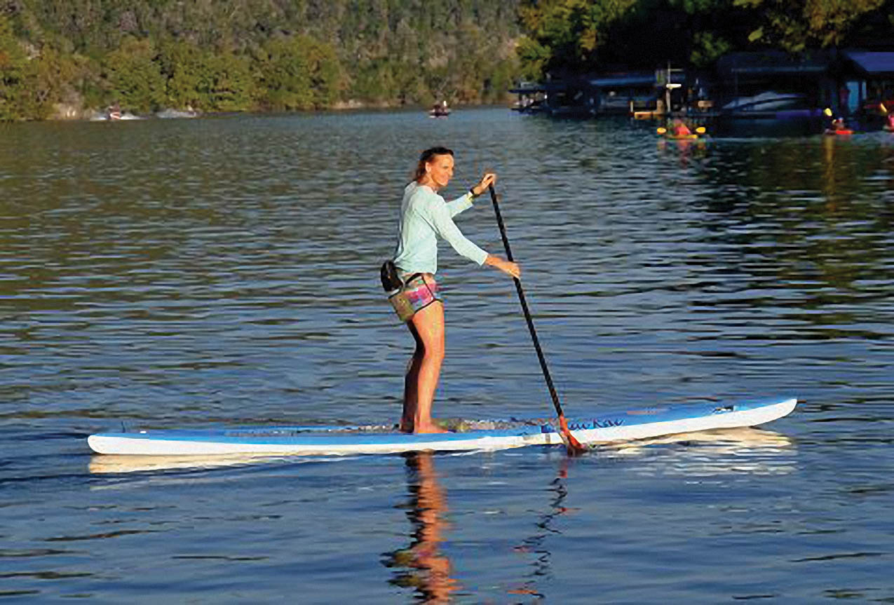 Kristin on a paddle board.