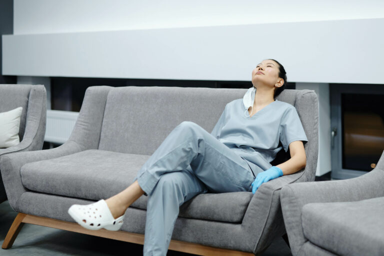 Nurse resting on a couch.