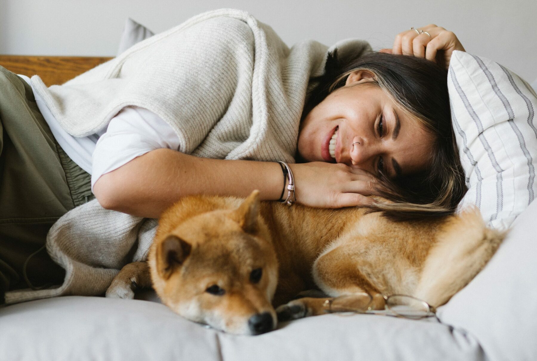 Woman laying with dog.