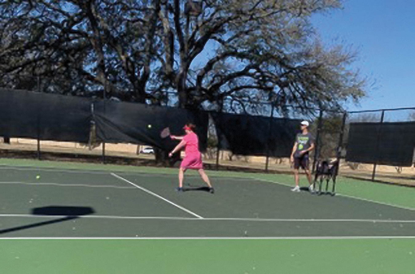 Meagan playing tennis.