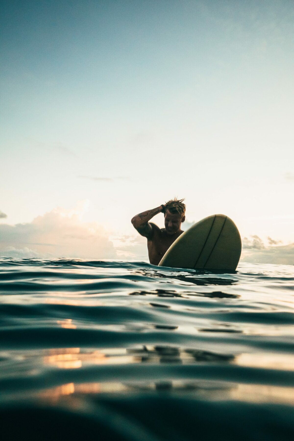 Man on surfboard in water.