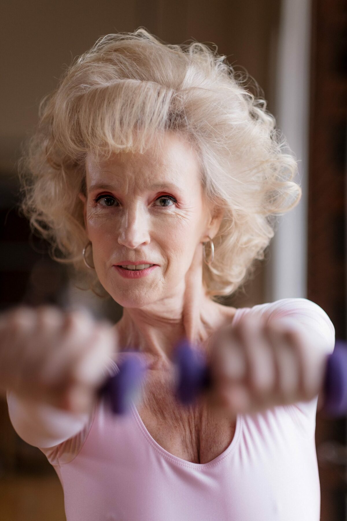 Older woman with dumbbells.