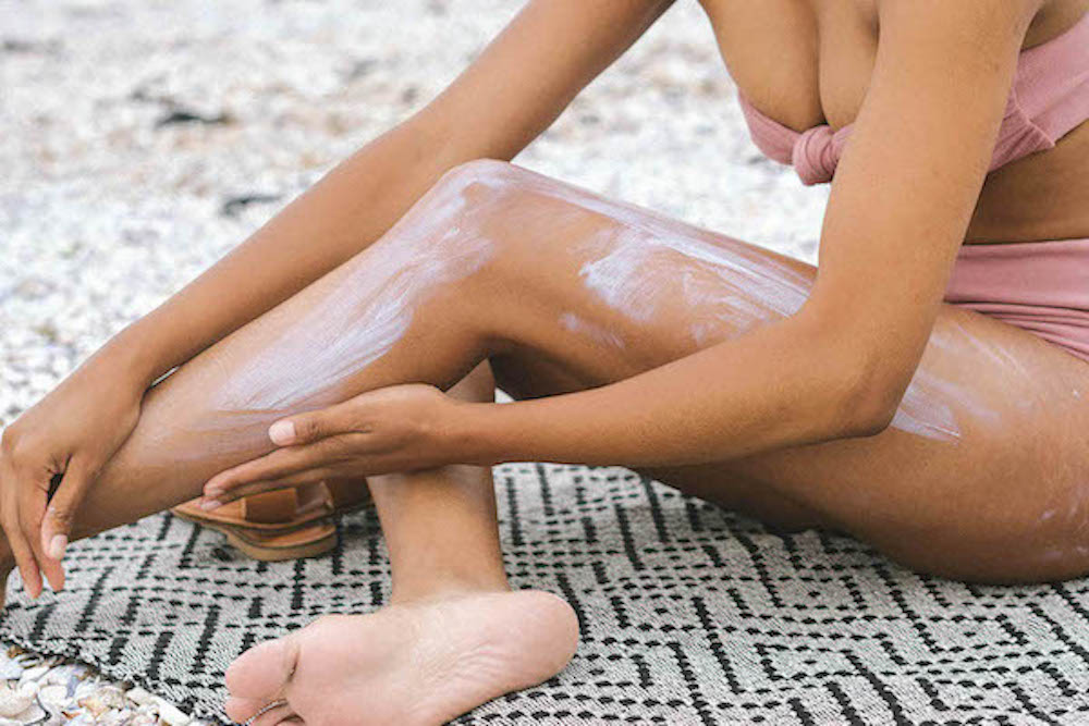 Woman applying sunscreen.