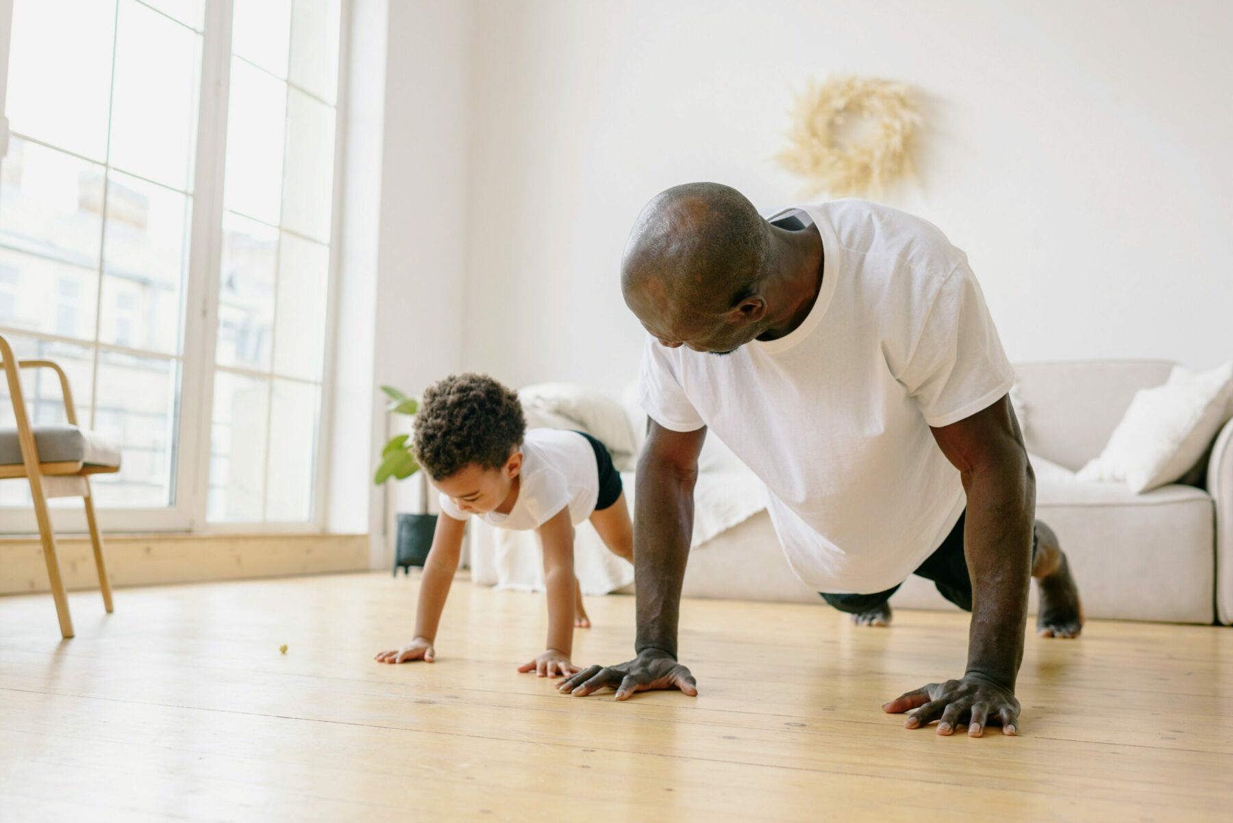 Father and son doing pushups.