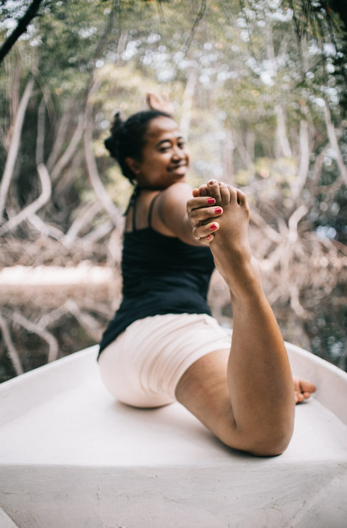 Woman smiling while doing yoga.