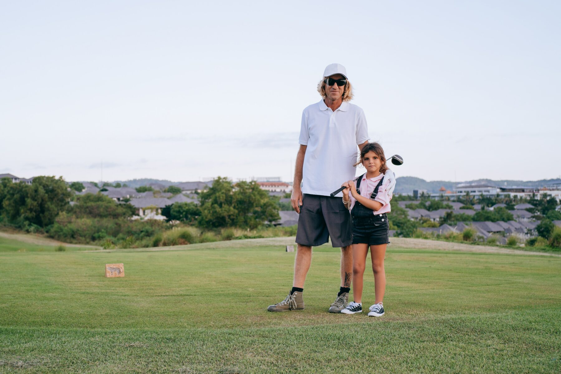 Dad and daughter golfing.