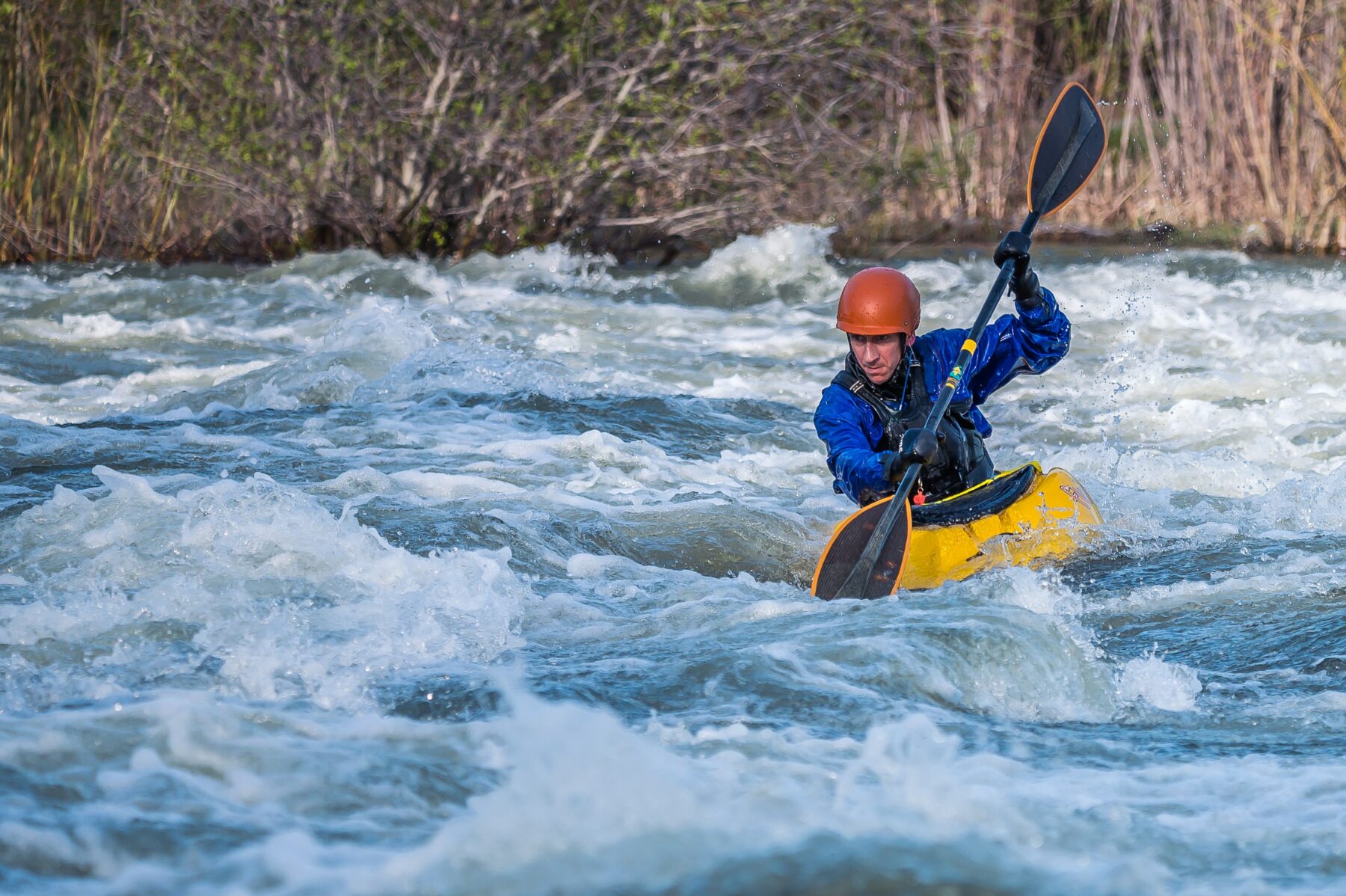 Person whitewater rafting.