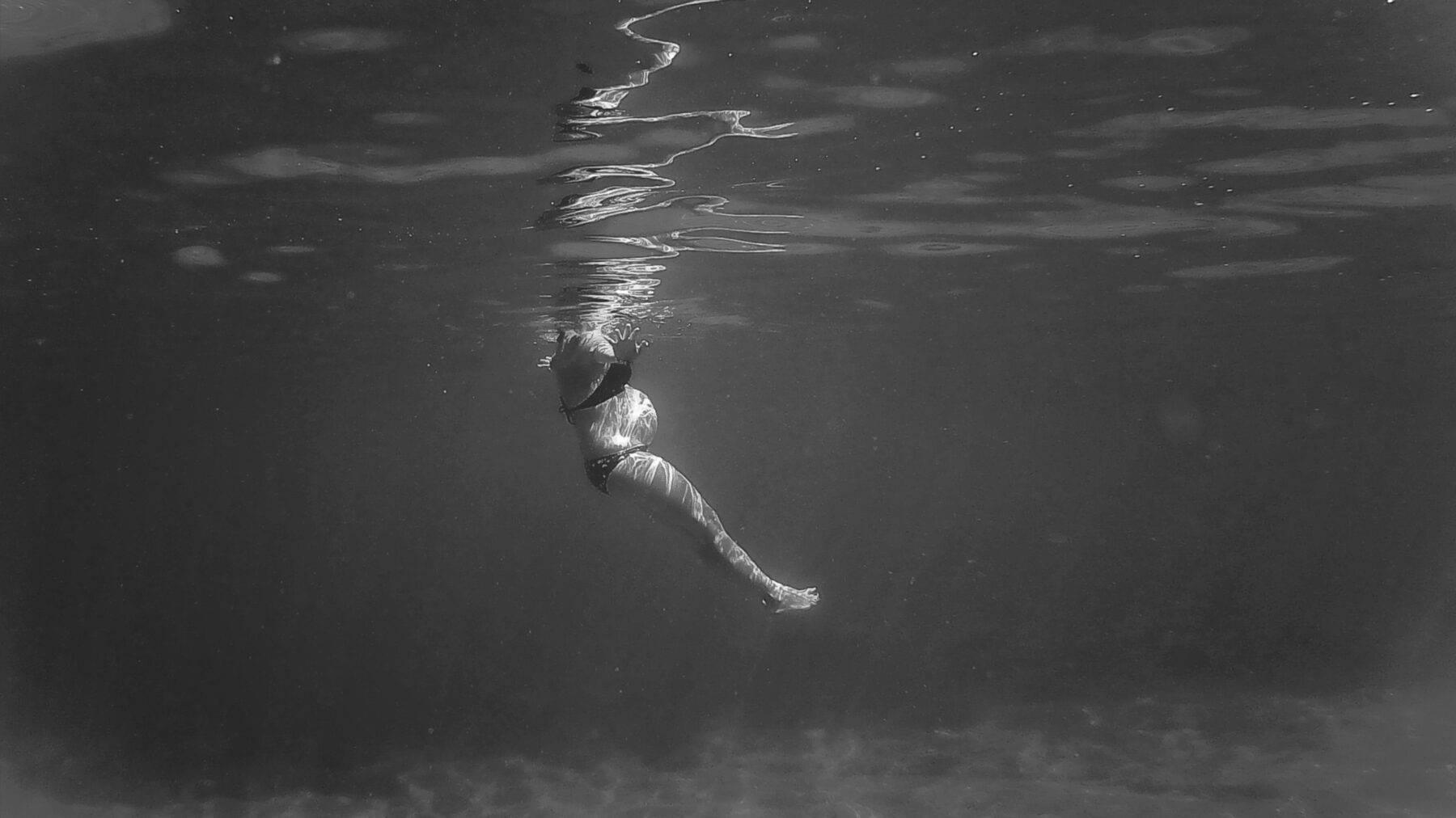 Pregnant woman swimming.